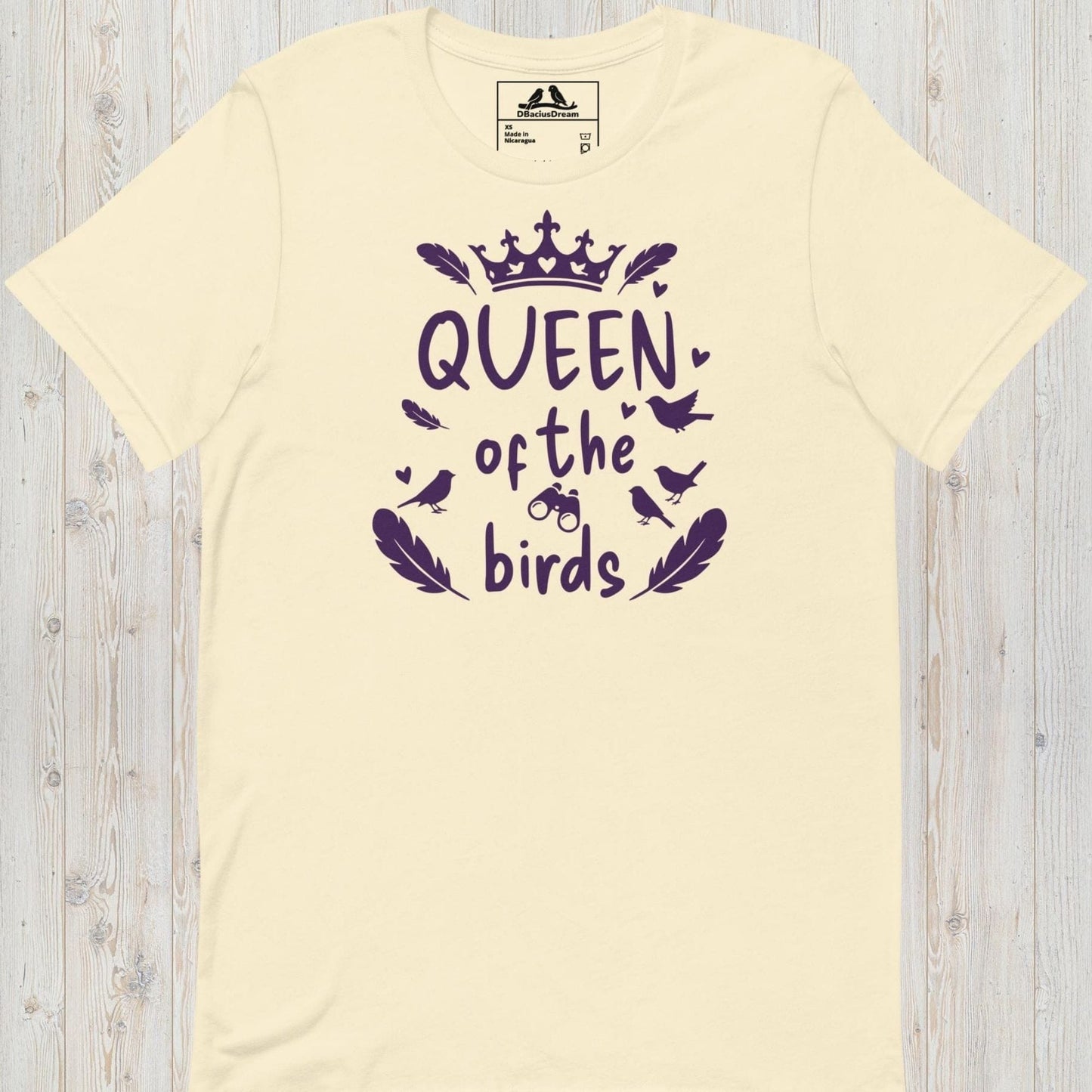Cream queen of the birds t-shirt with a purple bird graphic, crown design and decorative bird silhouettes