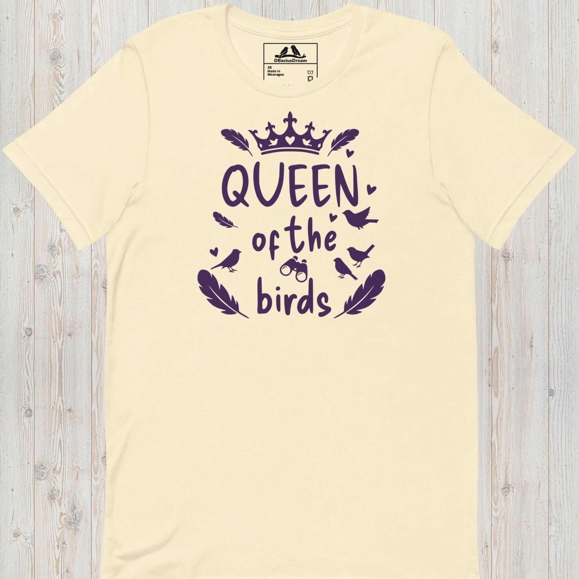 Cream queen of the birds t-shirt with a purple bird graphic, crown design and decorative bird silhouettes